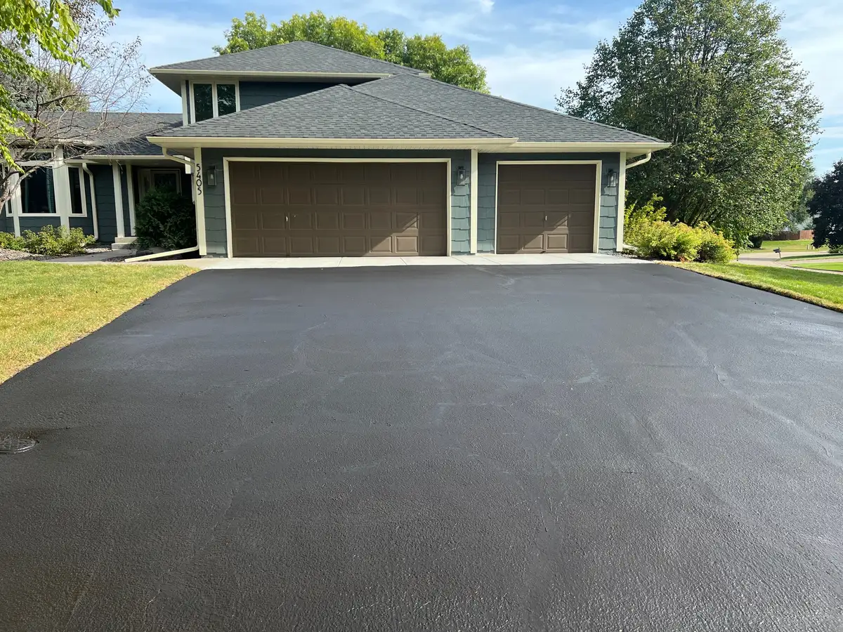 Three-car garage asphalt driveway in Twin Cities